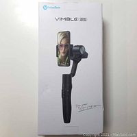 Front view of closed box showing FeiyuTech branding and Vimble 2S model with image of gimbal holding a smartphone.