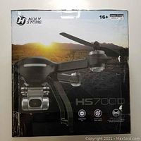 Retail packaging box showing Holy Stone HS700D branding, age rating, and frequency details