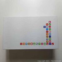 White retail box with colorful app icons on the surface, indicating phone packaging.