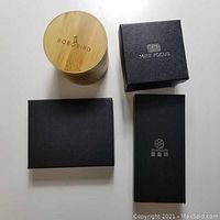 Four boxes including a bamboo box with Bobo Bird logo, Mini Focus box, Starking box, and one black box