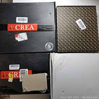 Four unopened or lightly opened boxes showing KES and CREA branding for bathroom fixtures.