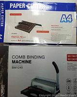 Photo showing paper cutter box with product specifications and image of cutter