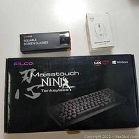 Filco Majestouch Ninja Tenkeyless keyboard box, Tijn Reliable Screen Glasses box, Wireless Mouse model D09 box.