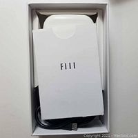 Open box with FIII branded packaging showing earpiece and USB cable.
