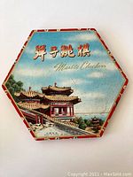 Top of hexagonal box showing traditional Chinese architecture with text 'Marble Checkers' and Chinese characters