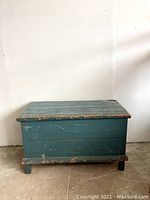 Front view of solid pine blue painted antique blanket box showing distressed paint and plank construction.