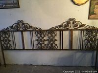 Full view of vintage metal headboard showing overall size, structure, and design.