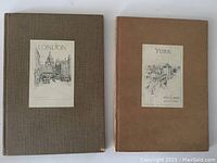 Two hardcover books side by side: London with brown textured cover, York with tan cover, both with sketch labels.