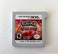 Front of Nintendo 3DS Pokemon Omega Ruby game cartridge showing label with game title and ESRB rating.