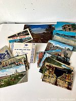 Top view of assorted vintage postcards from New York and New Orleans showing various landmarks and streetscapes.