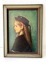 Full view of the framed portrait print showing the Alsatian girl in profile with green background and wooden frame.