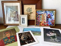 Eight art pieces arranged, four framed and four unframed prints with various subjects including floral, portrait, and interior scenes