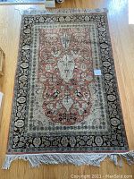 Full view of 4'x6' rectangular rug laid on hardwood floor.