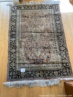 Full view of the rectangular rug laid flat on hardwood floor