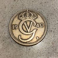 Obverse side of the 1940 Norway 50 ore coin featuring crowned G and date