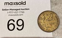 Photo of the 1953 French 50 Franc coin showing the front side with denomination and rooster design, placed on a MaxSold auction card.