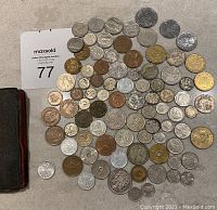 Overview of leather bill fold and spread of coins