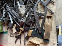 Wooden bench with assorted lathe tool bits, calipers, dividers, scribers and handles