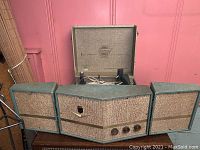 Front view of Fleetwood Model 661 turntable with attached 3-way speakers, fabric speaker covers, and control knobs visible.