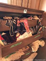 Dresser drawer with patterned scarves and assorted doll clothes visible.