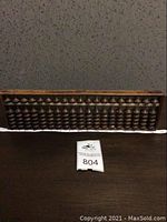 Full frontal view of the vintage wooden abacus, showing the full length of the bead rows and the overall condition of the frame.