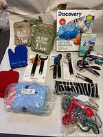 Photo showing full assortment of kitchen tools, mitts, pot holders, and miscellaneous kits and cloths.