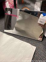 Reflective metal mirror box showing its size and condition.