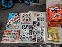Overall display of trading cards, posters, and memorabilia including Wheaties boxes and MLB themed items.
