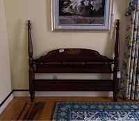 Full view of Hitchcock wooden bed frame headboard and footboard with rails and slats laid on floor.