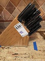 Side view of bamboo knife block filled with knives