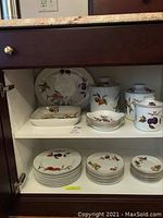Full cabinet view showing square serving bowl, round bowls and canisters