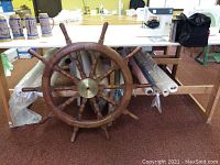 Full frontal view of steering wheel leaning against workbench