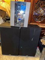 DiVinci D-50 Surround Sound Receiver displayed on top of two large black MTS speakers showing general condition and setup.