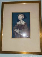 Close-up photo of Victorian watercolor print depicting a woman with a wide-brimmed hat in a gold-tone walnut frame.