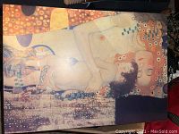 Front view of colourful framed art print depicting a naked mother and child with decorative patterns and warm colours.