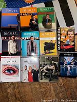 DVD box sets of House, Nip/Tuck, and Magnum P.I. arranged on a surface showing covers and season details.