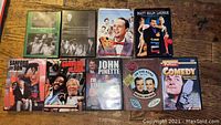 Photo showing all 9 assorted comedy DVDs including donated show and movie packs
