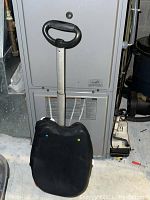 Back view of the wheeled backpack with handle extended, showing general shape and color.