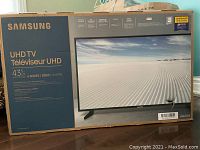 Box of Samsung UHD TV showing model, size, series