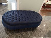 Overhead front angle showing tufted oval seat