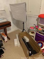 Assembled softbox on tripod stand with packaging boxes visible