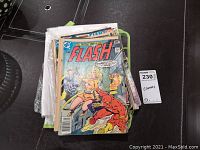 Stack of vintage comic books including The Flash, held together in plastic.
