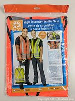 Front packaging of the new Hi-Vis orange traffic vest showing model wearing the vest and detailed description on the back of the packaging.