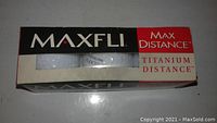 Box of 3 Maxfli Max Distance Titanium Distance golf balls in original packaging, new open box condition.