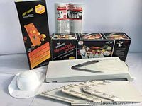 Full set of Borner V-Slicer Miracle-Chef De Luxe including main mandoline unit, three blade inserts, food holder, manual, and original box.