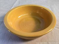 Front angled view showing yellow glaze and shape of vintage Fiesta bowl