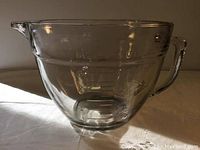 Full view of the large clear glass batter bowl with a handle and spout, showing the shape and overall design.