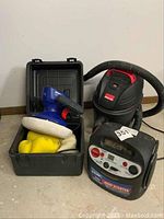 Polisher, shop vac and jump starter together showing full lot contents.