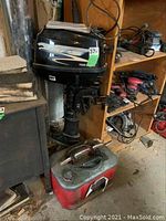 Overall view of APS outboard motor mounted on shelf with portable fuel tank positioned below