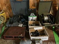 Overview of all items including Ryobi drill in case, Plomb puller box, Atlas inner tube, Dumore grinder, pilot bearing pullers